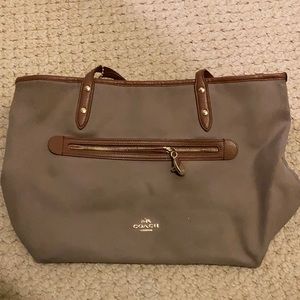 Coach tan bag with brown leather straps, gold fixtures and orange interior